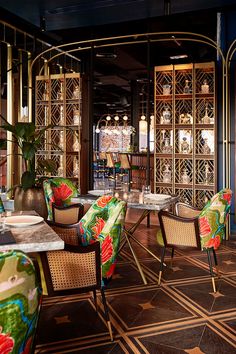 the interior of a restaurant with colorful chairs and tables