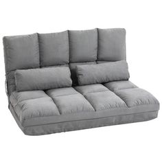 a gray couch with four pillows on the back and one arm folded up to show it's seat cushions