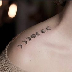 a woman with a tattoo on her chest that has phases of the moon