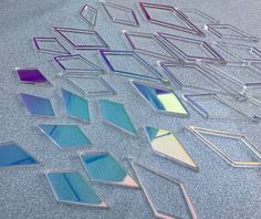 several pieces of glass sitting on top of a table next to each other in different colors