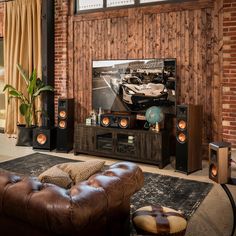 the living room is decorated in rustic wood and features an entertainment center with built - in speakers