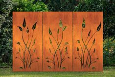 an orange screen with green plants on it in front of some trees and bushes behind it