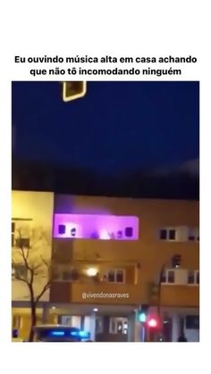 an image of a building that is lit up with purple lights in the night time