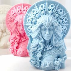 three soap molds with different designs on them, one in blue and the other in pink