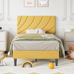 a child's bedroom with white walls and yellow furniture