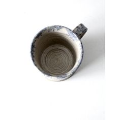 a blue and white cup sitting on top of a table