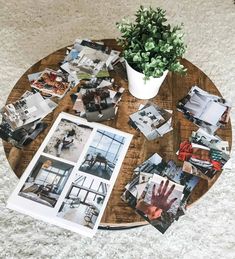 a coffee table topped with photos and a potted plant on top of the table