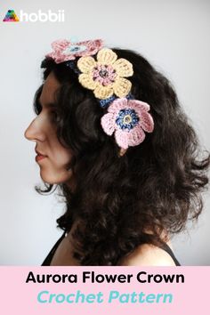 a woman with long hair wearing a crochet flower crown in pink, yellow and blue