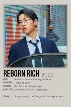 a man in a suit and tie standing next to a car with the words reborn rich on it