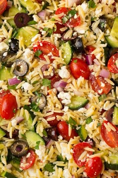 a salad with tomatoes, cucumbers, olives, and feta cheese