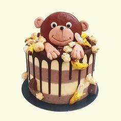 there is a cake decorated with a monkey on it's head and bananas around the top