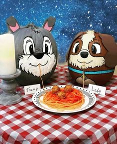 a table topped with plates of spaghetti and two cartoon characters sitting next to each other