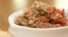 a white bowl filled with salsa and tortilla chips