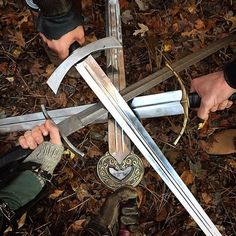 two people holding swords in their hands