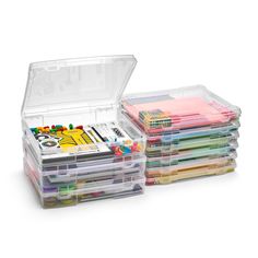 a stack of clear plastic boxes filled with lots of different colored pens and pencils