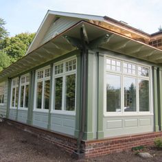 a green house with white trim and windows