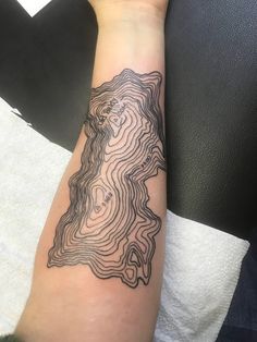 a person's arm with a tattoo on it that has a map in the middle