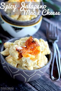 a bowl filled with macaroni and cheese on top of a wooden table