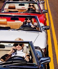 there are many people riding in the convertible cars