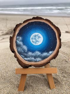 a piece of wood sitting on top of a sandy beach