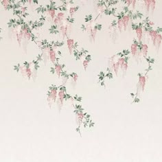 pink flowers on white wallpaper with green leaves and branches in the foreground, against a pale background