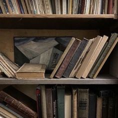 an old bookshelf filled with lots of different types of books on top of each other