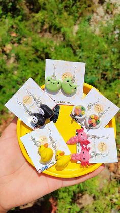 a hand holding a yellow plate with various items on it