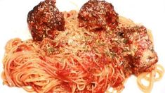 spaghetti with meatballs and parmesan cheese on top