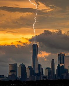 a lightning bolt is seen over the city skyline