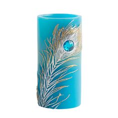 a blue vase with a gold feather painted on the front and side, sitting against a white background