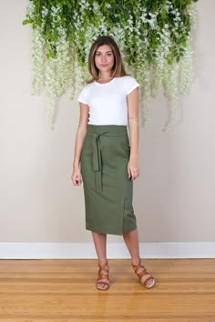 "Pull together the perfect mix of casual and professional style in your look with this ultra high waisted linen midi pencil skirt.  Raised waist, separate tie / belt, front vent and fitted silhouette with a below the knee hem. Medium weight linen blend fabric with a slight stretch is fully lined with a soft airy cotton voile to keep you cool and comfortable.  Invisible zipper closure on back.  Composition: 55% Linen, 43% Rayon, 2% Spandex  Lining: 100% Cotton Care: Dry clean recommended. Hand wa Linen Pencil Skirt, Green Pencil Skirt, Layering Cardigan, Olive Green Skirt, Olive Skirt, Green Pencil, Green Pencil Skirts, Navy Pencil Skirt, Belted Skirt