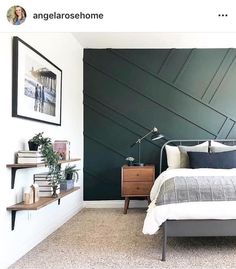 a bedroom with a bed, nightstands and bookshelves on the wall next to it