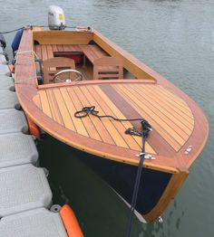 a small wooden boat docked in the water