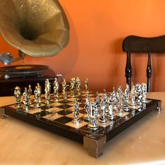 a chess board sitting on top of a table next to a record player's instrument