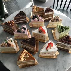 a table topped with lots of different types of cakes on top of eachother