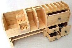 an unfinished wooden desk with drawers and pegs on the bottom shelf is shown in front of a white background