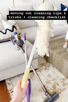 a woman is cleaning the floor with a mop and duster in her hand