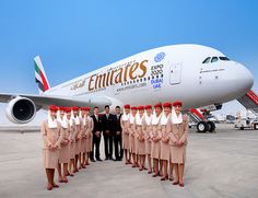 a group of people standing in front of an airplane