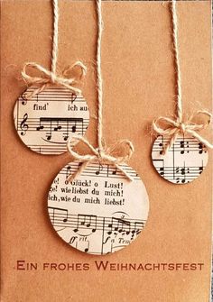 two tags with musical notes on them hanging from twine strings that are attached to string