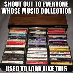 a wooden box filled with lots of different types of music cassettes on top of each other