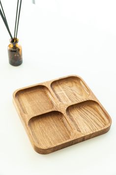 a wooden tray with three compartments on it