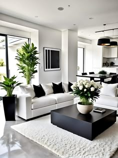 a living room filled with white furniture and lots of plants on top of a rug