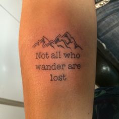 a tattoo with the words not all who wander are lost written in black ink on someone's arm