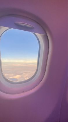 an airplane window looking out on the clouds