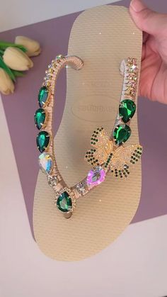 This is a collection of elegant and luxurious thong sandals that are adorned with dazzling rhinestone crystals. Designed for brides and weddings, these sandals combine comfort with a touch of glamour, making them ideal for walking in style on special occasions. Jewel-encrusted Havaianas with the sparkle of crystals make them a perfect accessory for high-end events and weddings, adding a touch of luxury to your bridal wardrobe or any occasion that requires sophisticated footwear. Wonderful sanda Elegant Party Flip Flops With Open Toe, Elegant Open Toe Party Flip Flops, Elegant Party Flip Flops, Glamorous Green Sandals With Rhinestones, Bedazzled Round Toe Beach Sandals, Bedazzled Round Toe Sandals For Beach, Bling Open Toe Sandals For Beach, Elegant Green Sandals With Rhinestones, Elegant Single Toe Strap Flip Flops For Vacation