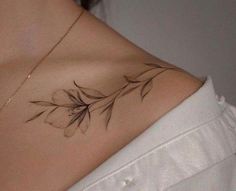 a woman's chest with leaves on it