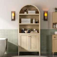 a bath room with a toilet a sink and a book shelf on the wall next to a tub