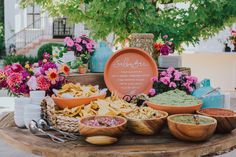 a table topped with bowls and plates filled with food