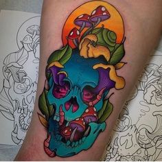 a colorful skull tattoo on the leg