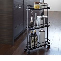 a kitchen cart with bottles and glasses on it